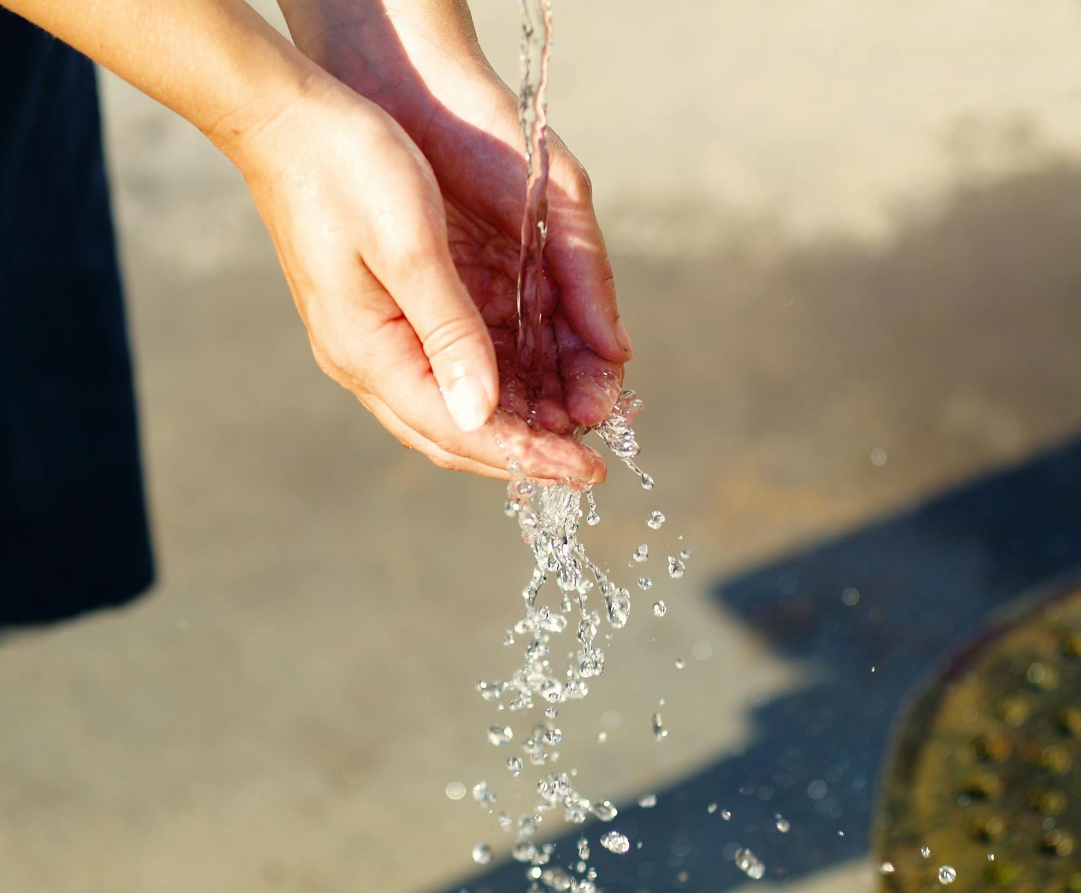 Water running through cupped hands.