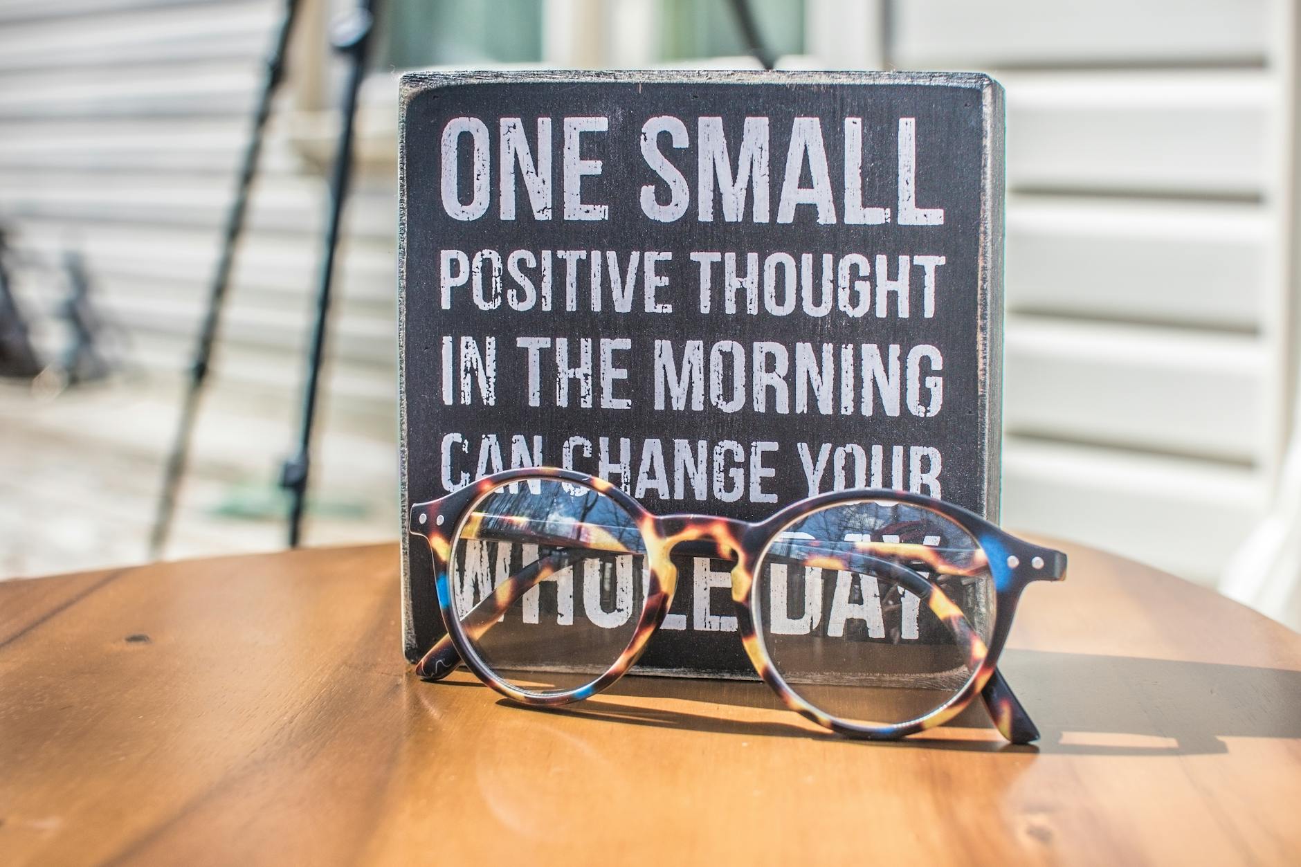 A sign says, "One small positive thought in the morning can change your whole day."