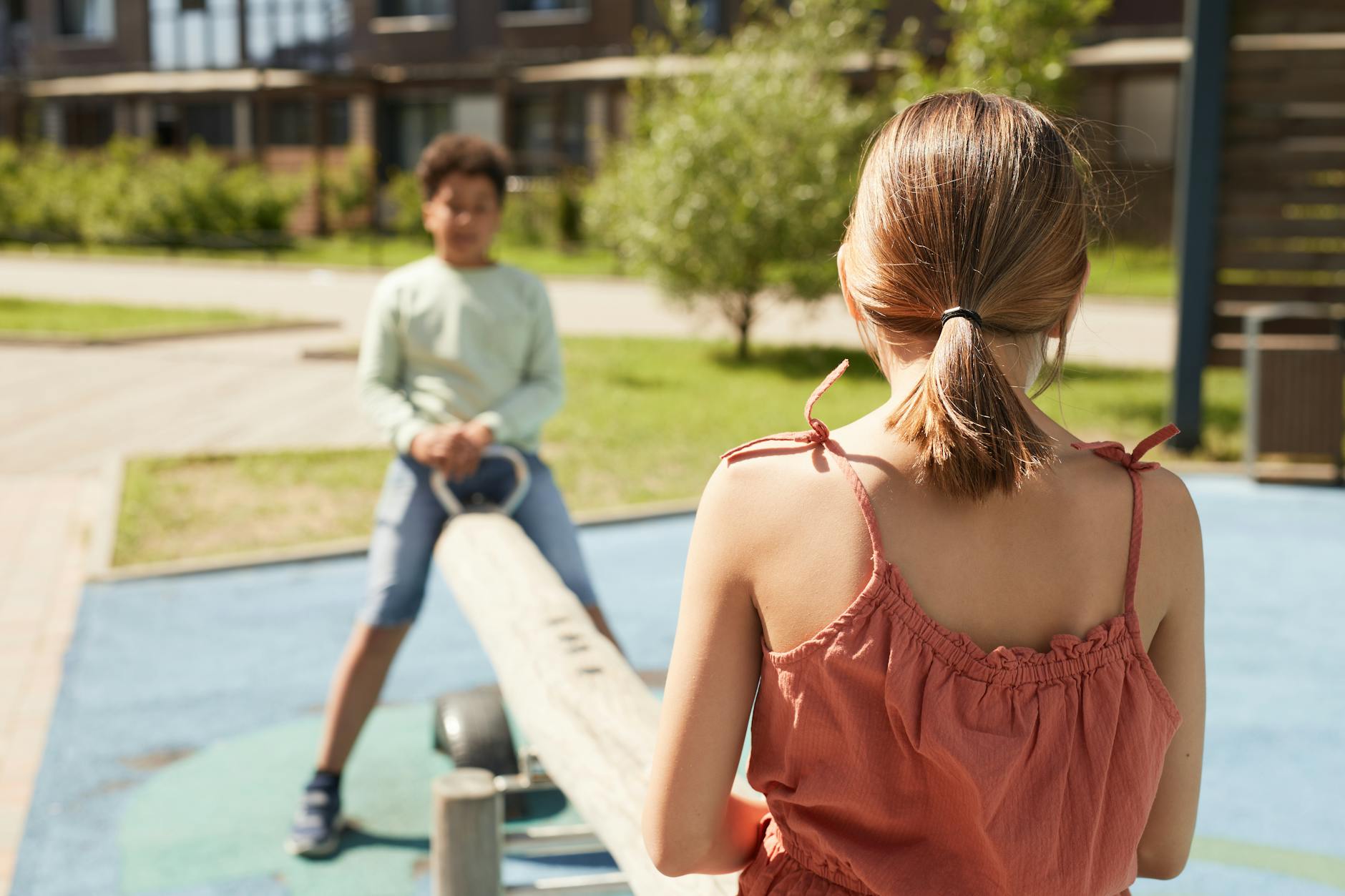 Two children on a seesaw.