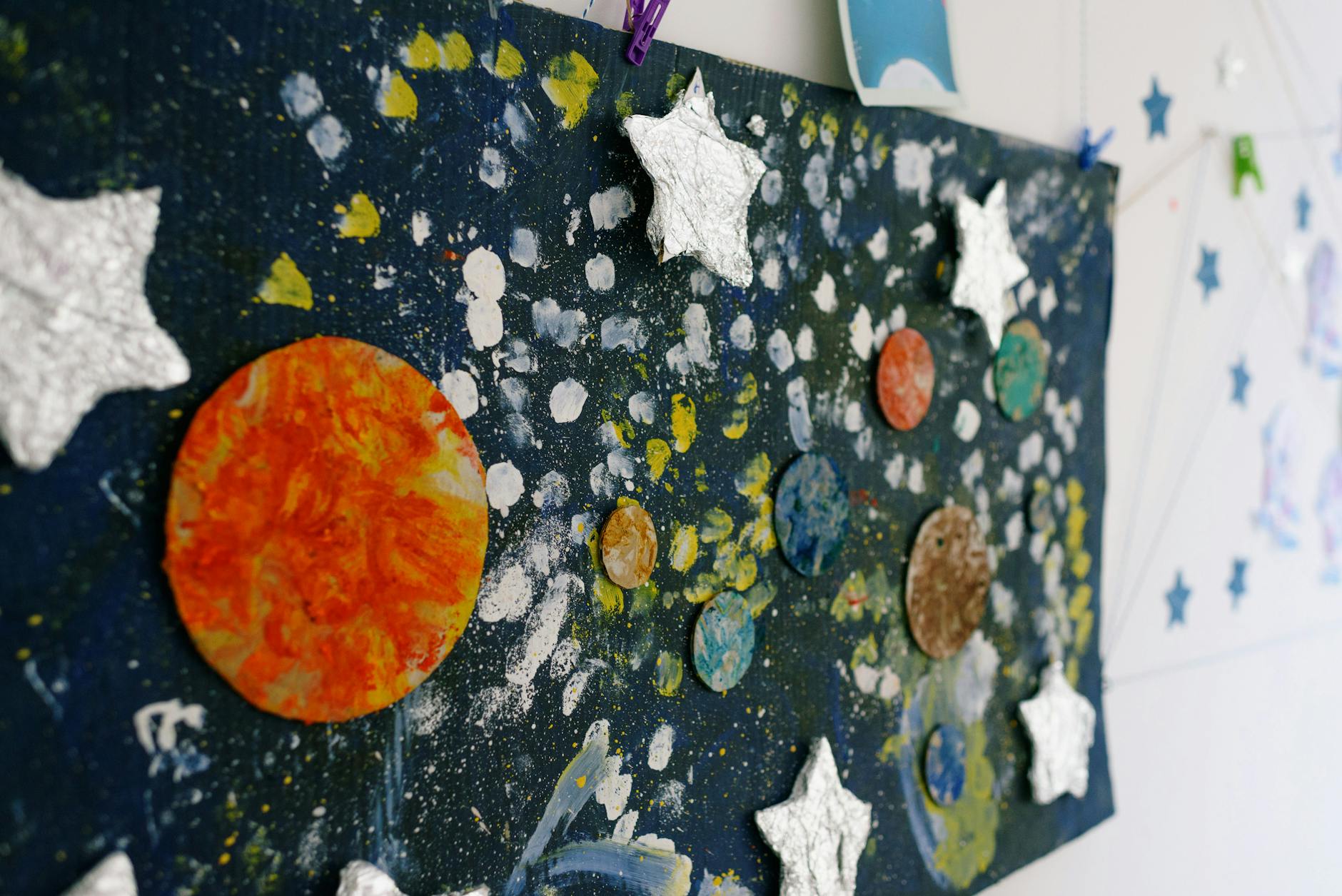 A child's collage of stars and planets.
